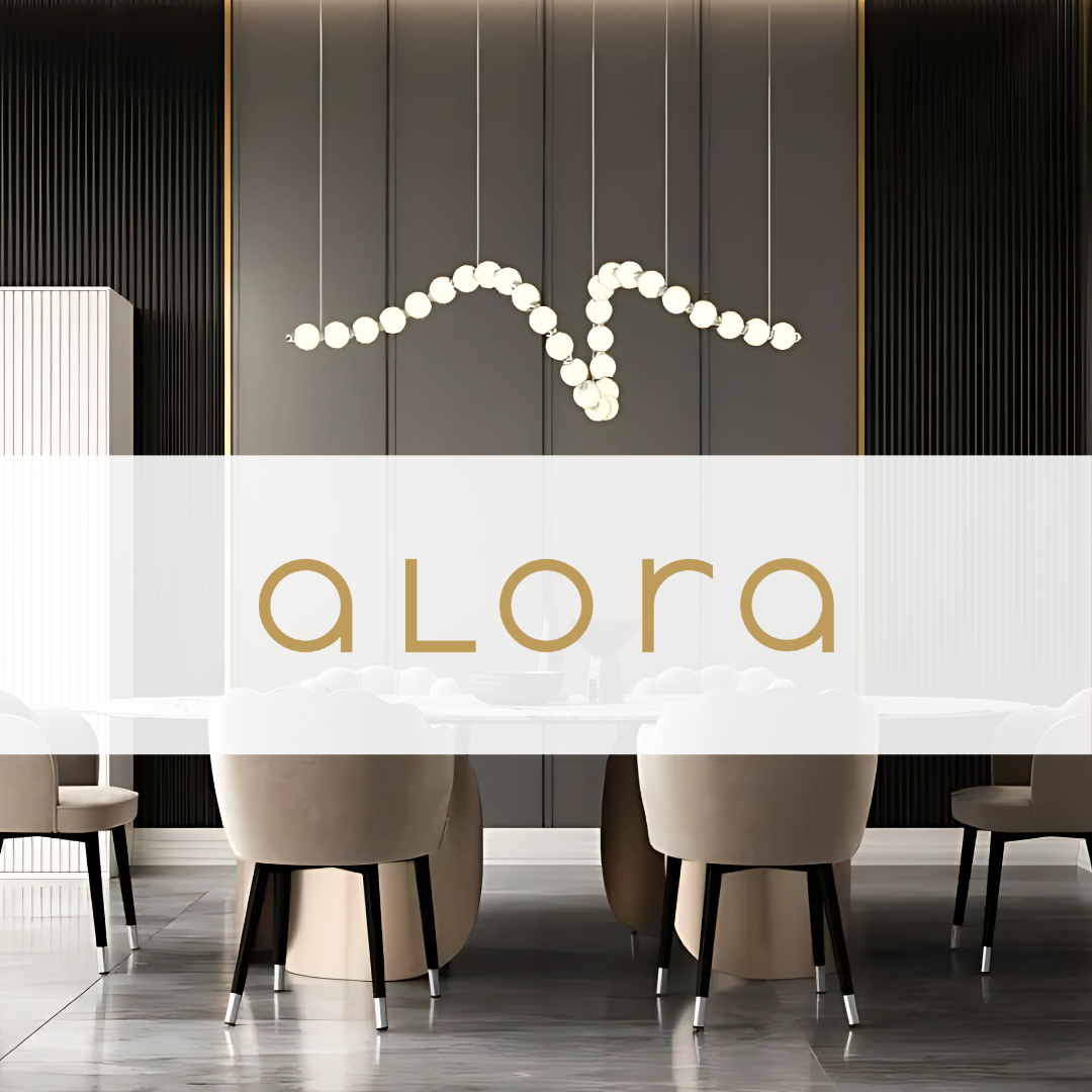 Modern dining room featuring a sculptural Alora Lighting pendant chandelier suspended above a sleek white table, with velvet dining chairs and dark accent walls.
