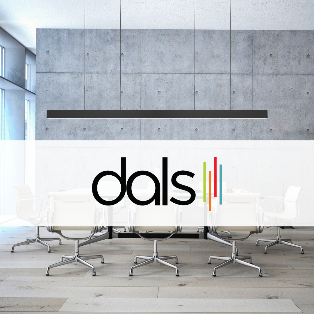 Dals Lighting modern linear LED pendant suspended in a contemporary conference room with concrete accent wall, white swivel chairs, and minimalist design