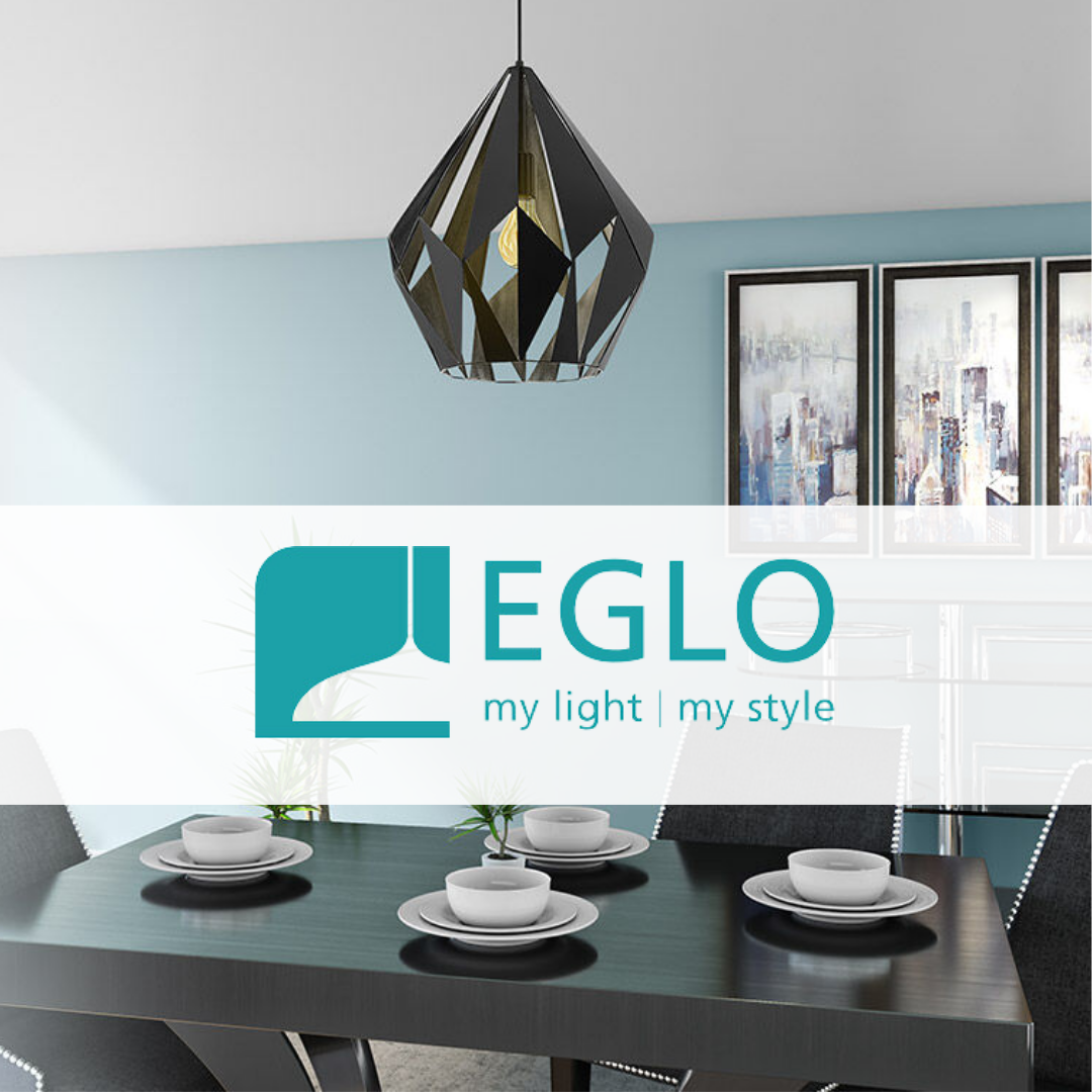 Eglo geometric black pendant light hanging over a modern dining table set with white dishes, against a light blue wall with contemporary artwork