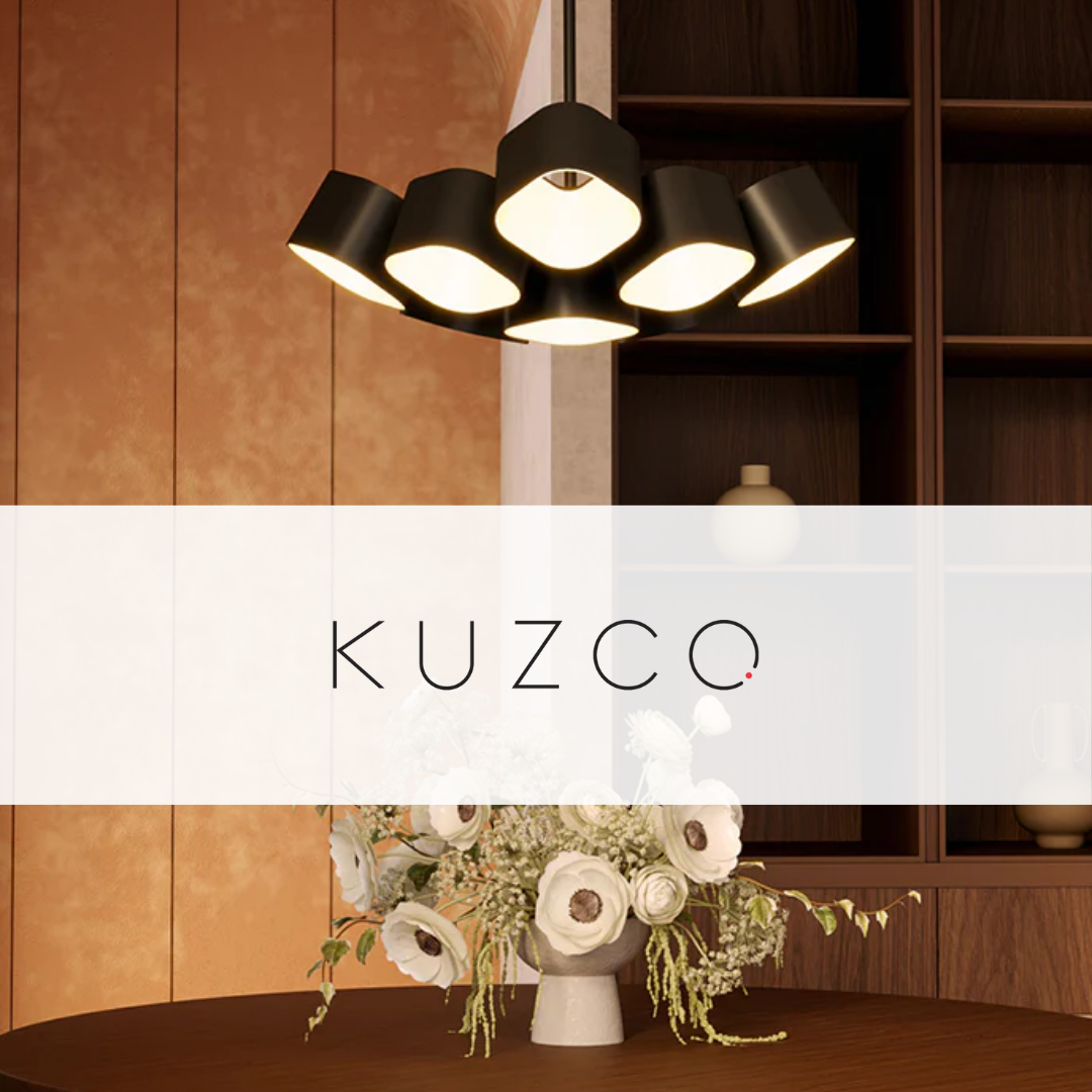 Kuzco Lighting modern black pendant chandelier above a dining table with floral centerpiece in a warm-toned contemporary interior