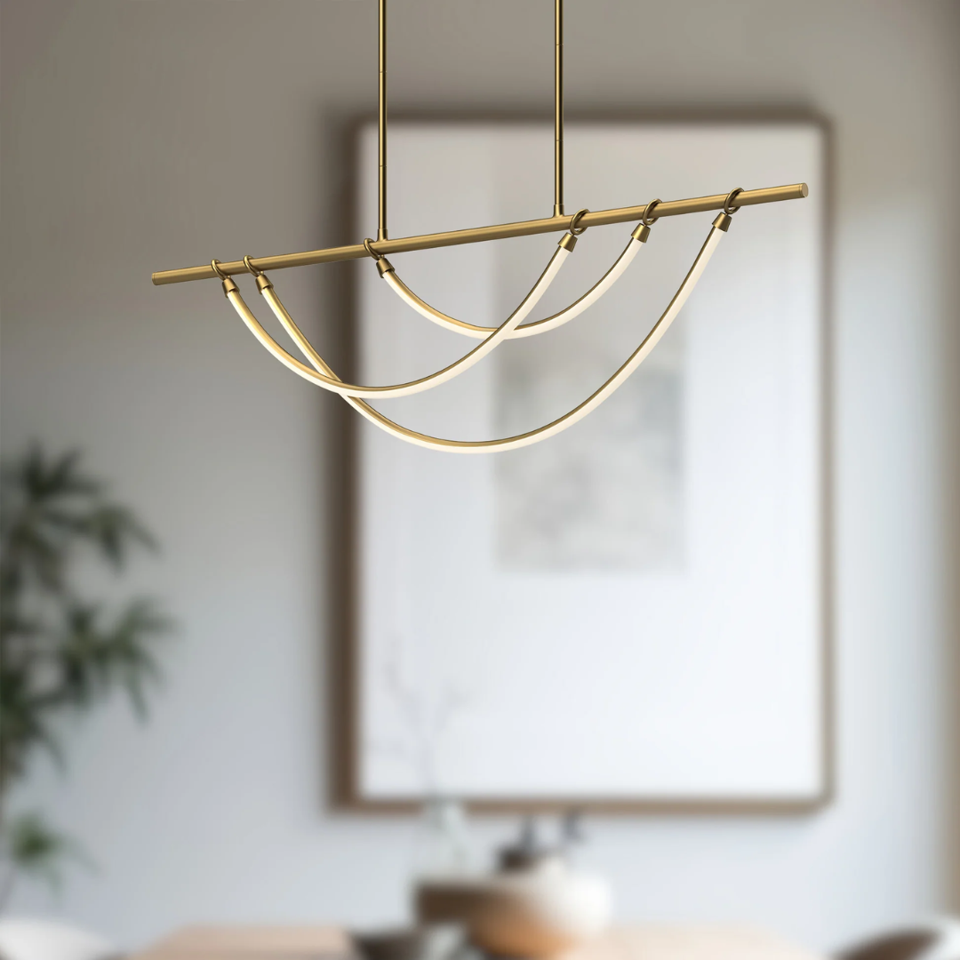 Modern linear island pendant by Alora Lighting featuring curved LED light bars suspended from a sleek brass rod, perfect for kitchen islands or dining areas