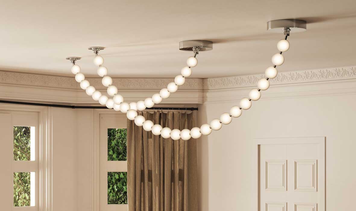 Modern ceiling-mounted globe chandelier by Alora Lighting with a cascading bead-like design, installed in an elegant living room with crown molding