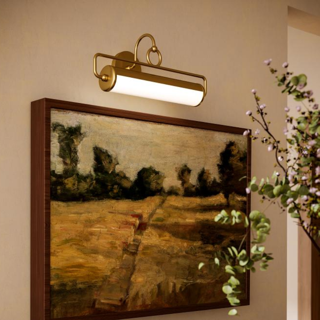 Brass picture light by Alora Lighting mounted above a framed landscape painting, offering focused LED illumination—ideal for galleries, hallways, or art walls
